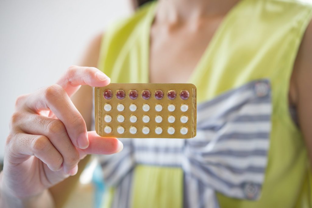 woman hand holding contraceptive panel prevent pregnancy scaled 1